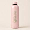 A matte light pink insulated water bottle with a matching pink cap, featuring 'The Open University' printed vertically in a muted sage green on the front, set against a solid light beige background.